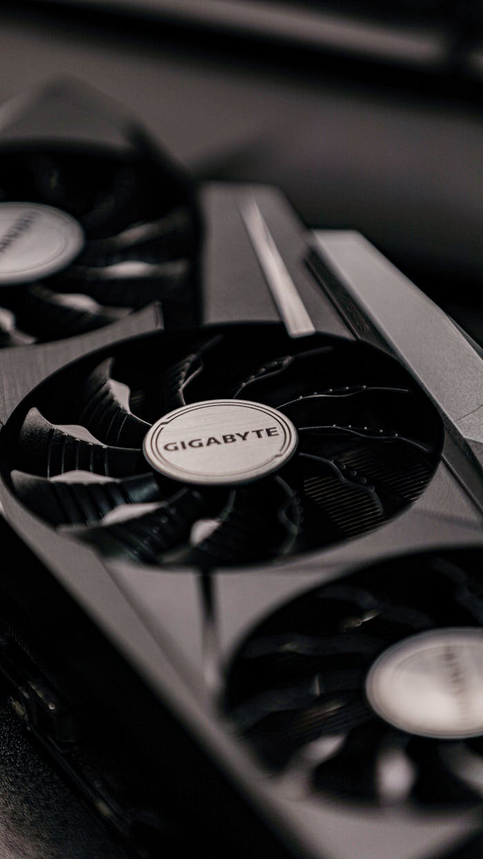 Contemporary specialized electronic black video cards with inscriptions for generating feed of output images to display device placed on table in room